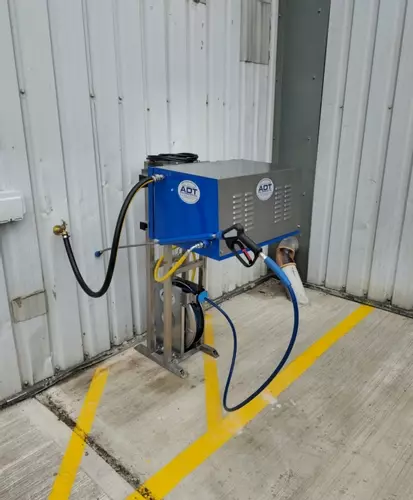 Nilfisk DTE cold static pressure washer mounted on a custom stainless steel frame with retractable hose reel for ambulance washing in Leicester. Nilfisk DTE pressure washer installed on a custom stainless frame with retractable reel for fast ambulance was